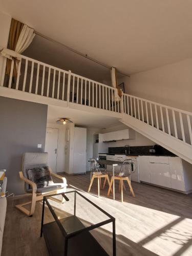 - un salon avec un escalier, une table et des chaises dans l'établissement Saint Tropez City Loft, à Saint-Tropez