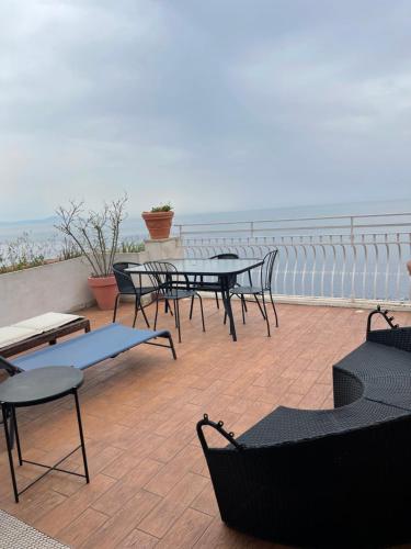 a group of tables and chairs on a balcony overlooking the ocean at Hostel Brikette in Positano