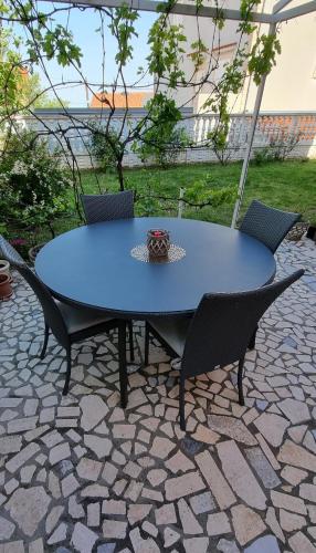 a blue table and chairs on a patio at Three stars in Senj