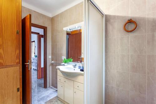 a bathroom with a sink and a mirror at Casa Maria Elena by dracmallorca in Cala Santanyi