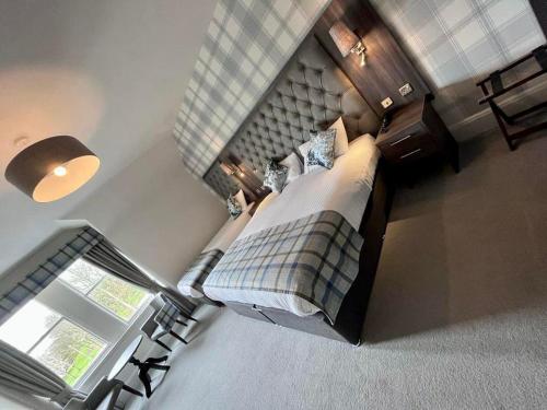 an overhead view of a bedroom with a bed and a window at Fife Lodge Hotel in Banff
