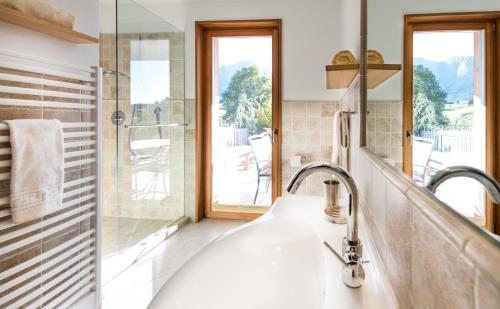 a bathroom with a sink and a shower at Apartments Elisir in Castelrotto