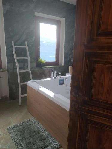 a bathroom with a bath tub and a window at Giardino sul Lago SPA Jacuzzi in Castel Gandolfo