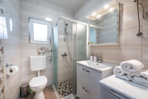 a bathroom with a toilet and a sink and a shower at Apartments My Dubrovnik in Dubrovnik