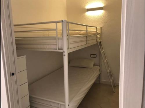 a room with two bunk beds in a room at Résidence Novelty Vue Mer Centre Sea View in Salou