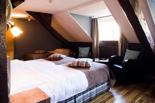 a hotel room with two beds and a window at La Fontaine du Sabotier in Awenne
