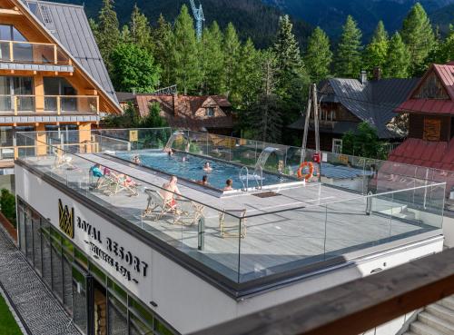 a large swimming pool on the top of a building at VisitZakopane - Royal Resort Wellness & SPA in Zakopane
