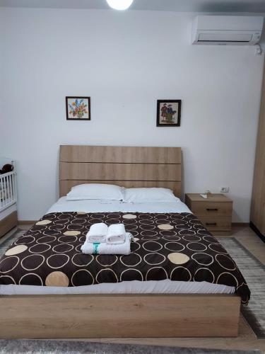 a bedroom with a bed with two towels on it at Guesthouse Belle View Old Town in Berat