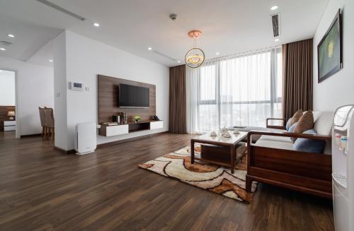 a living room with a couch and a table at Nesta - The Grand Hao Nam in Hanoi