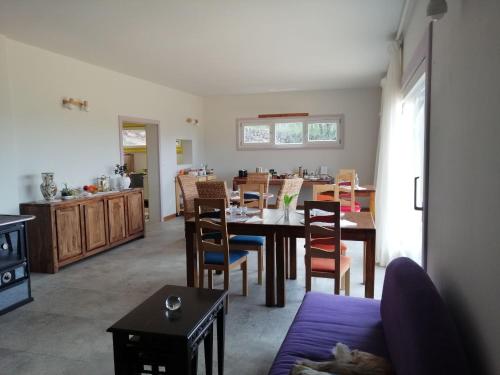 a kitchen and dining room with a table and chairs at LES JARDINS CELESTES in Saint-Genest-de-Bauzon