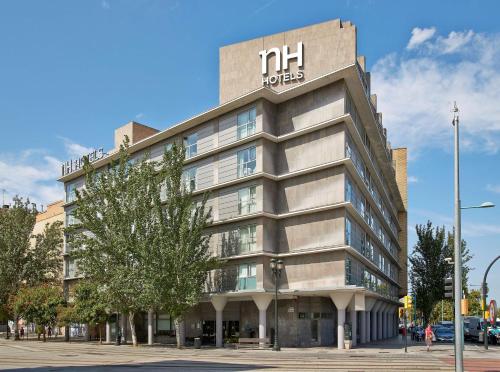 un edificio con un cartello dell'hotel sopra di NH Ciudad de Zaragoza a Saragozza