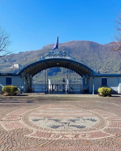 a building with a tile floor in front at Casa Vacanza Nonno Gigi in Mandello del Lario