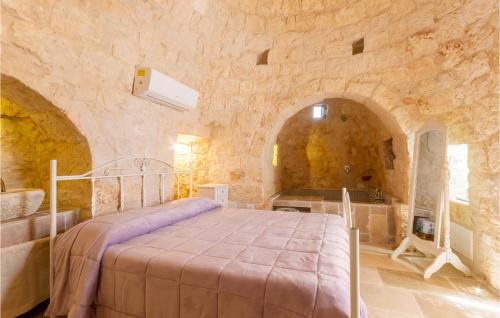 a bedroom with a bed in a stone wall at 2 Bedroom Amazing Home In Ostuni in Ostuni