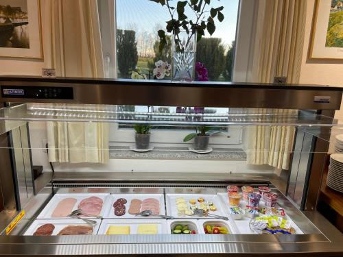a refrigerator with meat and other foods in it at Land-gut-Hotel am Ring in Meuspath