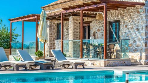 a villa with a swimming pool and lounge chairs at Zante Poolside Paradise - La Vite Stone Villa in Kalipádhon