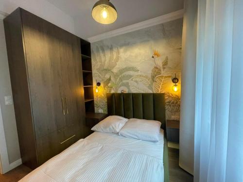 Un pat sau paturi într-o cameră la Royal Aparthotel Kamienica Nova 2