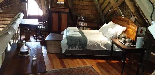 a bedroom with a bed in a log cabin at The Lapa in Durban