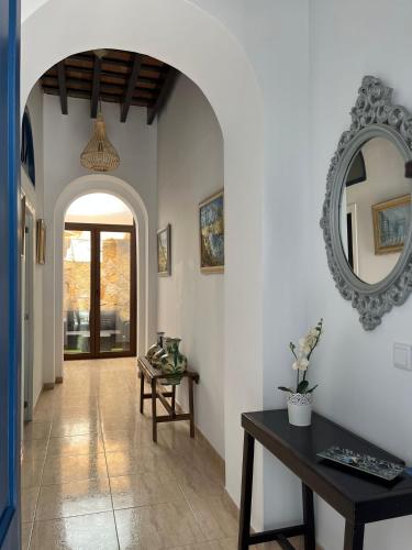 a hallway with a table and a mirror on the wall at Casa Ribera Centro in Ayamonte