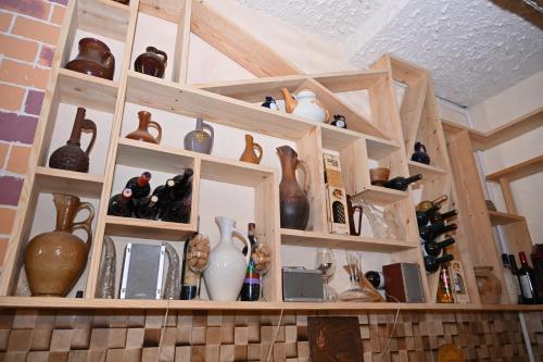 a shelf filled with lots of vases and vases at Berkri Gastro Yard & Guest House in Yenokavan