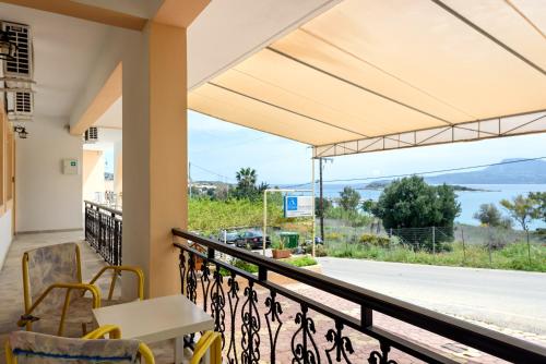 a balcony with a table and chairs and a view at Angela Apartments new listing in Marathi