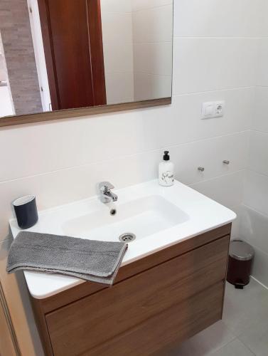 a bathroom with a white sink and a mirror at Tranquility Arimar Apartment Puerto Rico in Puerto Rico de Gran Canaria
