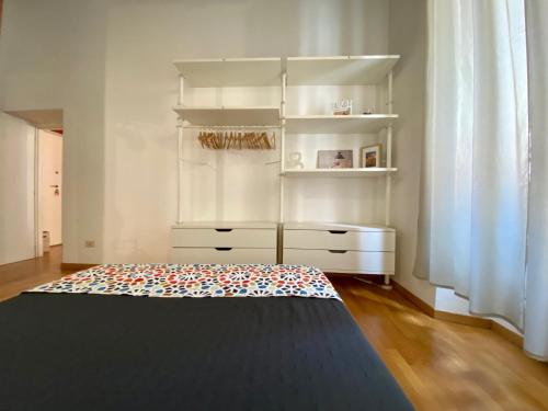 a bedroom with a dresser and a bed in a room at Barberini Apt close to Fontana di Trevi in Rome