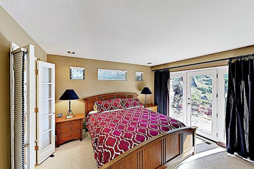 a bedroom with a large bed and a window at Heavenly Retreat in Stateline