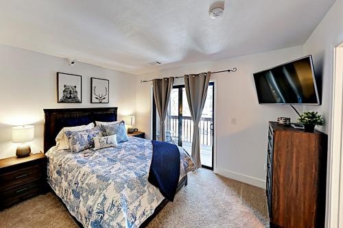 a bedroom with a bed and a flat screen tv at Boulder Condo N in Stateline