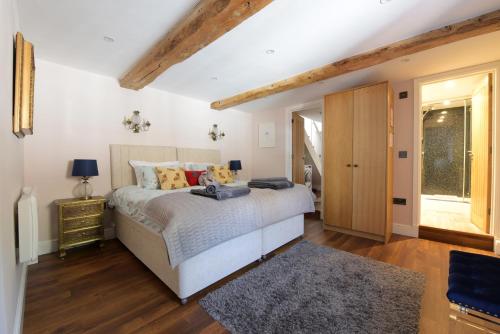 a bedroom with a bed and a wooden floor at Stone Barn in Minehead