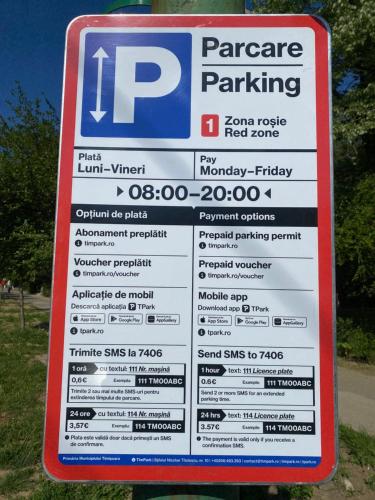 a sign for parking at a parking lot at Take PRO Timisoara Apartment in Timişoara