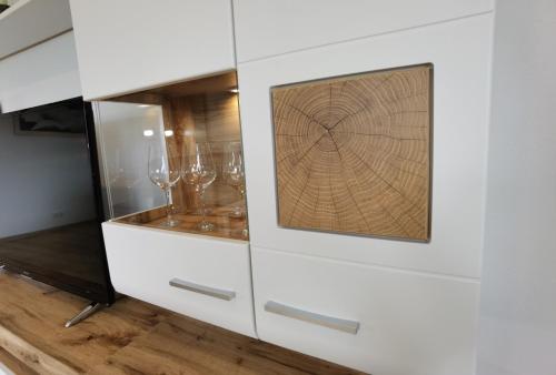 a white cabinet with two wine glasses in it at Ferienwohnung Hockertz in Habscheid