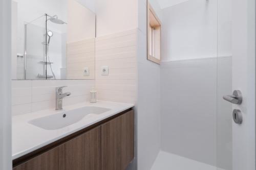 a bathroom with a sink and a mirror at Goabio Studio River View in Porto