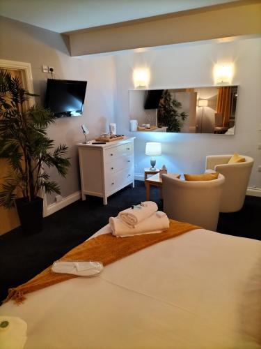 a bedroom with a bed with two towels on it at Sutherlands Hotel in Gateshead