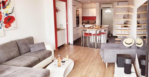 a living room with a couch and a kitchen at Marina Sunset in Le Grau-du-Roi