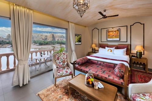 a bedroom with a bed and a balcony at WelcomHeritage Cheetahgarh Resort & Spa in Bera