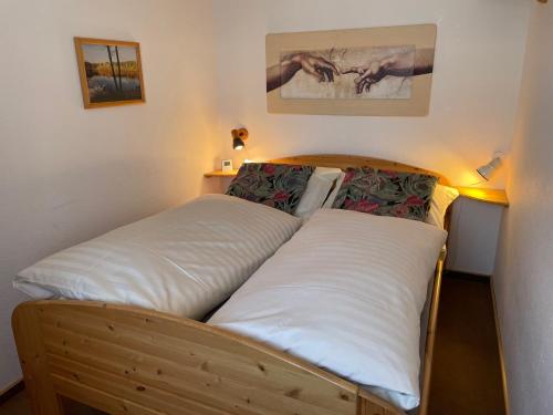 a bed in a room with two white pillows at Apartment Cora in Winterberg