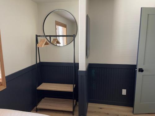 a room with a mirror and a wooden stool at Pinedale Cozy Cabins in Pinedale