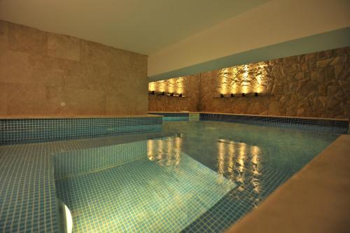 a large swimming pool in a building at Garden Spa Boutique Hotel in Skopje