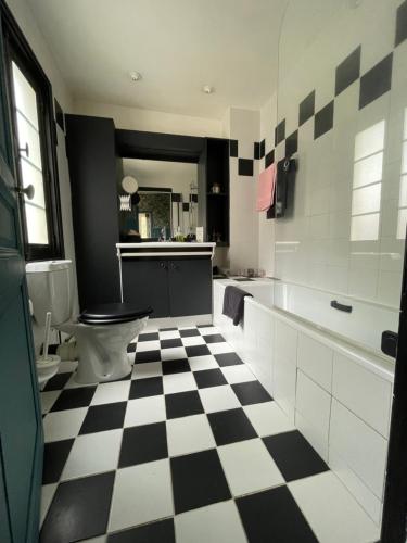 baño con suelo a cuadros en blanco y negro en Gîte les Remparts, en Pierrefonds