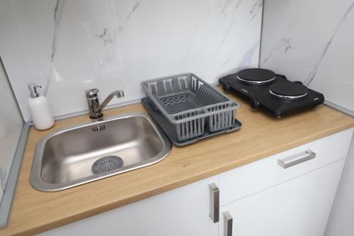 a kitchen sink with a basket on a counter at Apartman Normanci near Bizovac thermal spa in Normanci
