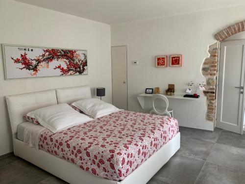 a bedroom with a bed with a red and white blanket at Horse Shoe House in Chiaverano