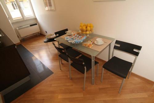 a dining room table with chairs and fruit on it at Vatican Sunset Guest House in Rome