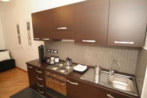 a kitchen with a sink and a counter top at Vatican Sunset Guest House in Rome