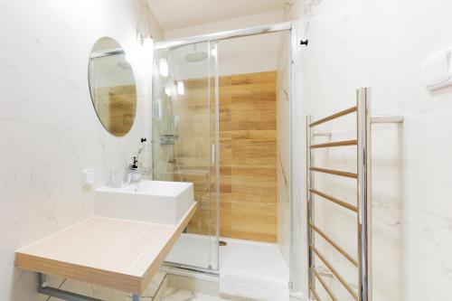 a bathroom with a sink and a shower at Penzion Kersko in Hradišťko