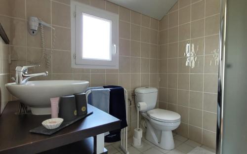 a bathroom with a sink and a toilet at LES STUDIOS DE SARLAT in Sarlat-la-Canéda