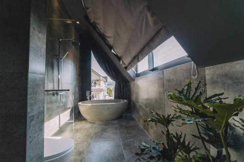 ein Badezimmer mit Badewanne und Waschbecken in der Unterkunft Bliss House Đà Lạt in Da Lat