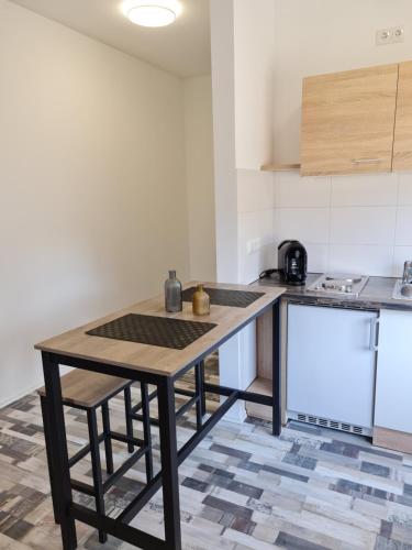 a kitchen with a wooden table in a room at City Apartment in Osnabrück
