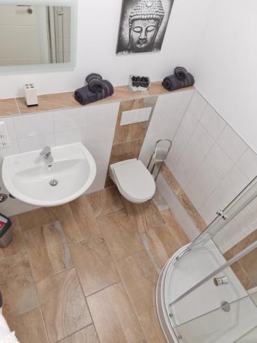 ein Bad mit einem Waschbecken und einem WC in der Unterkunft City Apartment in Osnabrück