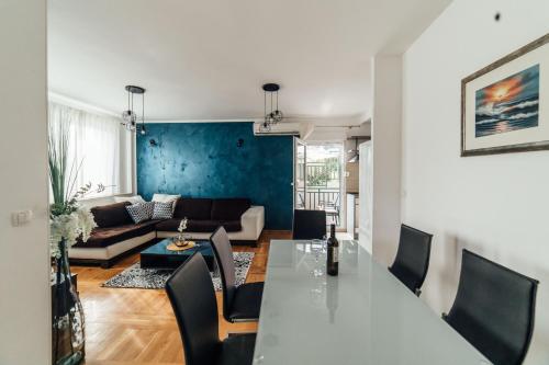 a living room with a table and a couch at Villa Lidija in Omiš