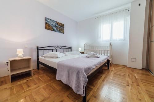 a bedroom with a bed and a wooden floor at Villa Lidija in Omiš